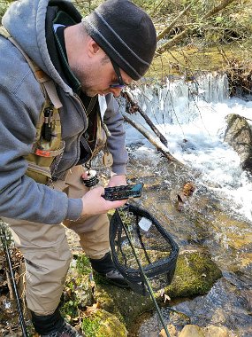 $StoneCabin 2-21-2022003$ Gary getting a pic of one of the few we netted.